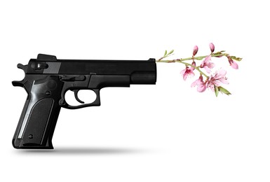 Image of Beautiful blooming flowers and handgun on white background. Peace instead of war