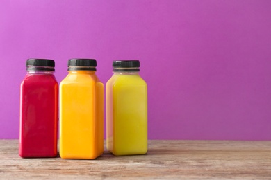 Bottles with delicious detox smoothies on table