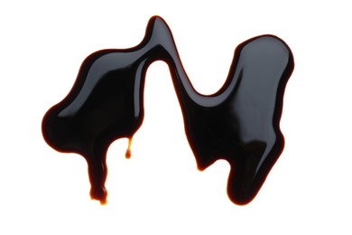 Photo of Spilled soy sauce on white background, top view