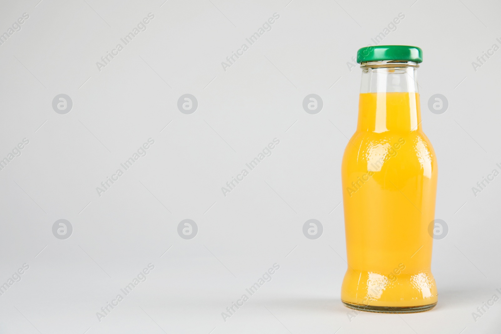 Photo of One bottle with tasty drink on color background. Space for text