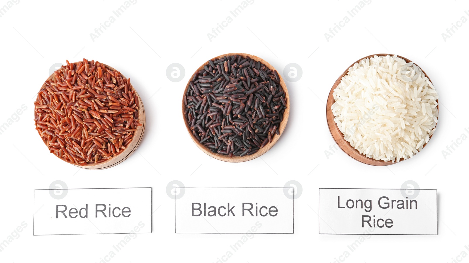 Photo of Bowls with different types of uncooked rice and cards on white background, top view