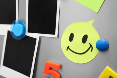 Photo of Sheets of paper and photos with colorful magnets on refrigerator door, closeup. Space for text