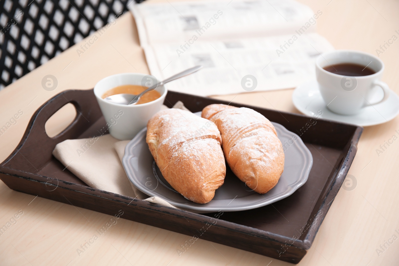 Photo of Tasty breakfast with fresh croissants and jam on tray