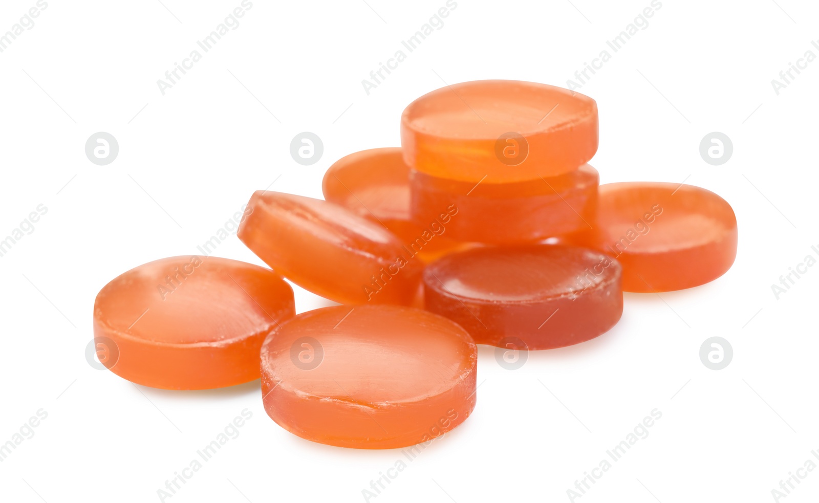 Photo of Many orange cough drops on white background