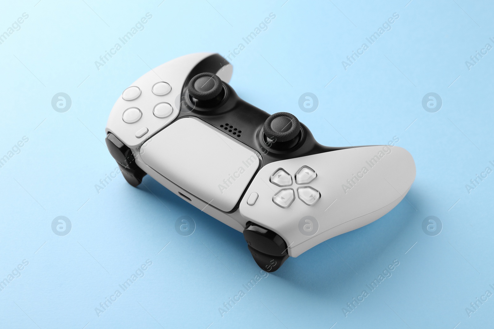 Photo of Wireless game controller on light blue background