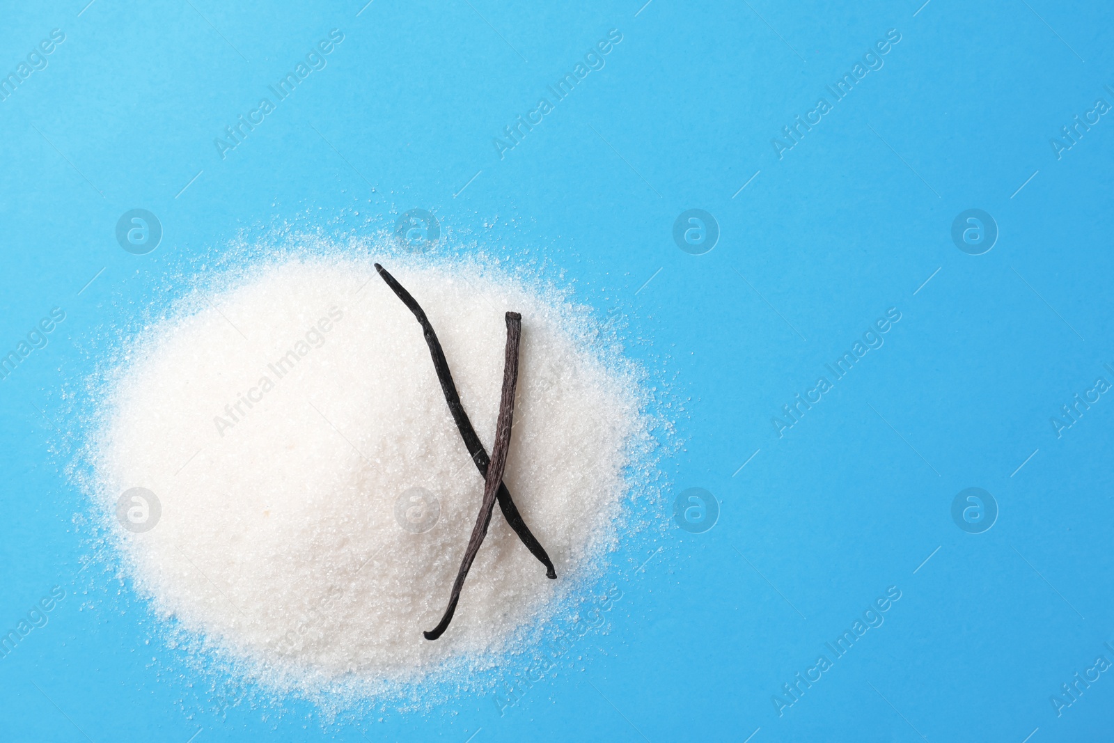 Photo of Pile of vanilla sugar on color background, top view