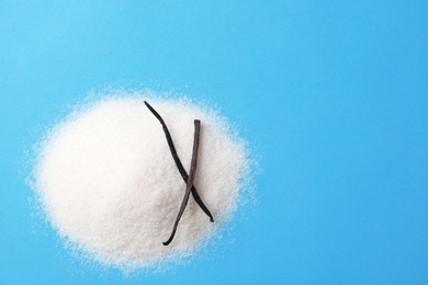 Photo of Pile of vanilla sugar on color background, top view