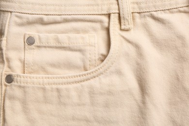 Photo of Beige jeans with inset pocket as background, closeup
