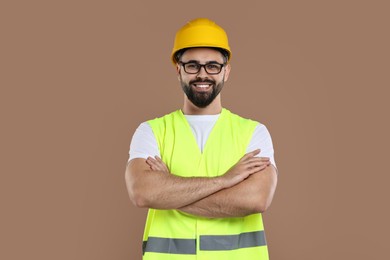 Photo of Engineer in hard hat on brown background