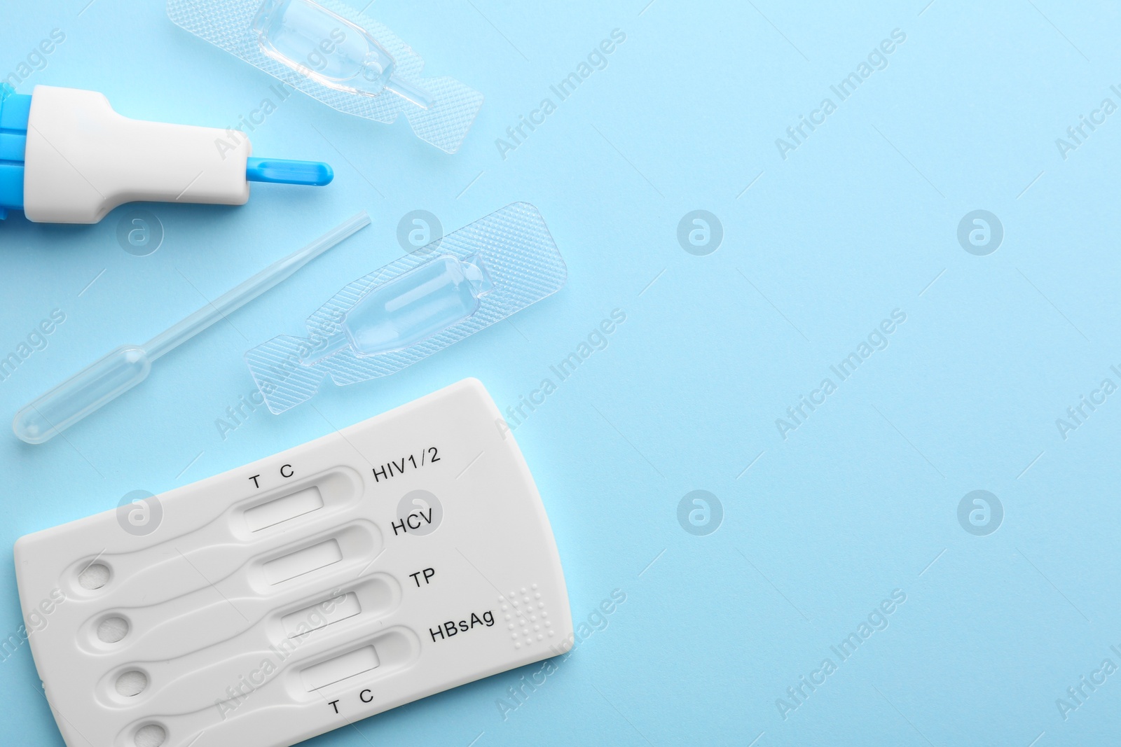 Photo of Disposable multi-infection express test kit on light blue background, flat lay. Space for text