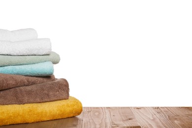 Photo of Soft colorful terry towels on wooden table against white background, space for text