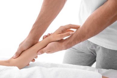 Photo of Young woman receiving massage in salon, closeup