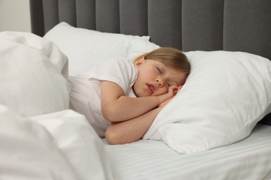 Photo of Little girl snoring while sleeping in bed