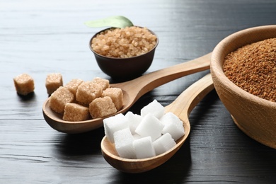 Photo of Various kinds of sugar on wooden background