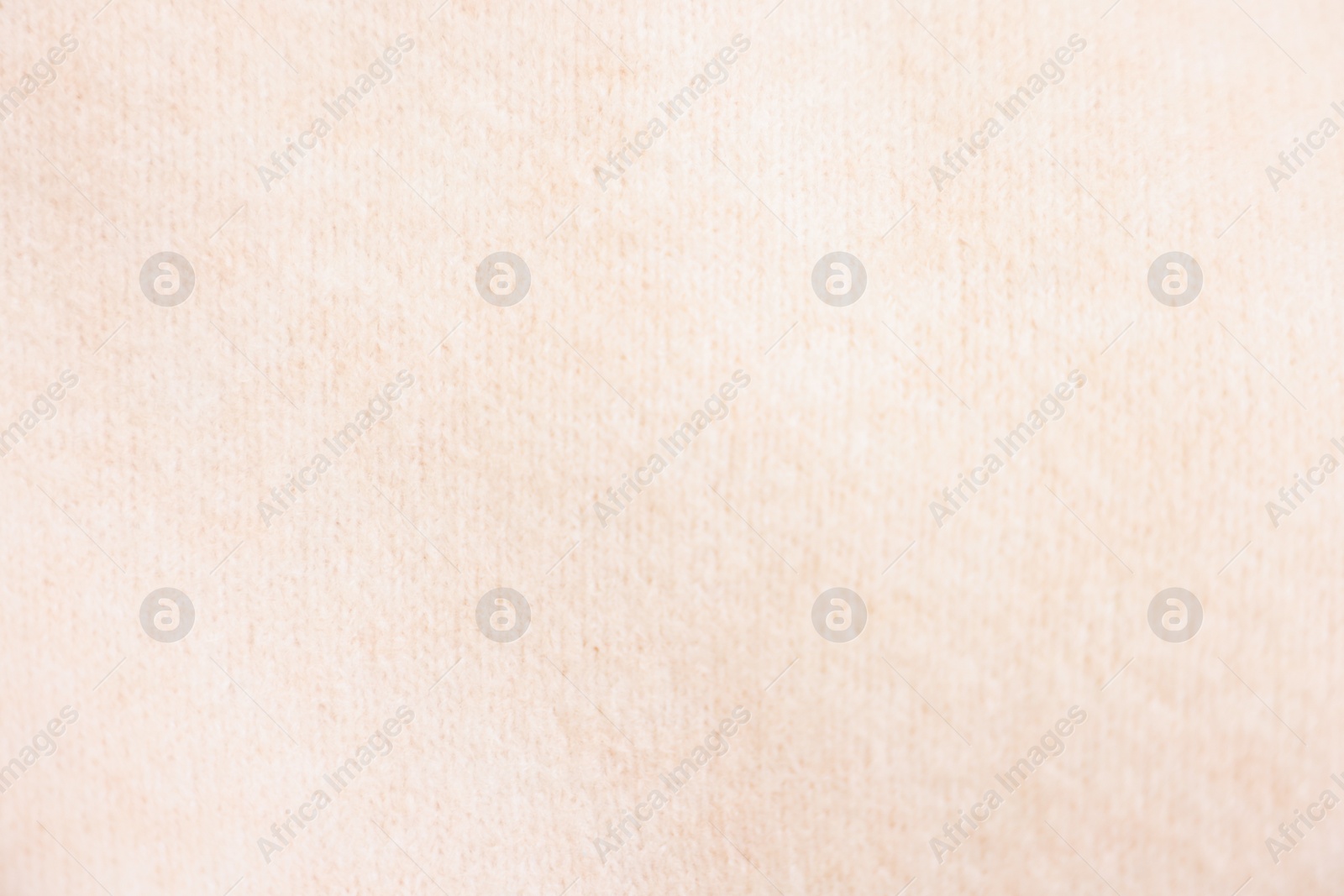 Photo of Texture of soft beige sweater as background, top view