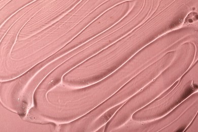 Cosmetic gel on pink background, top view