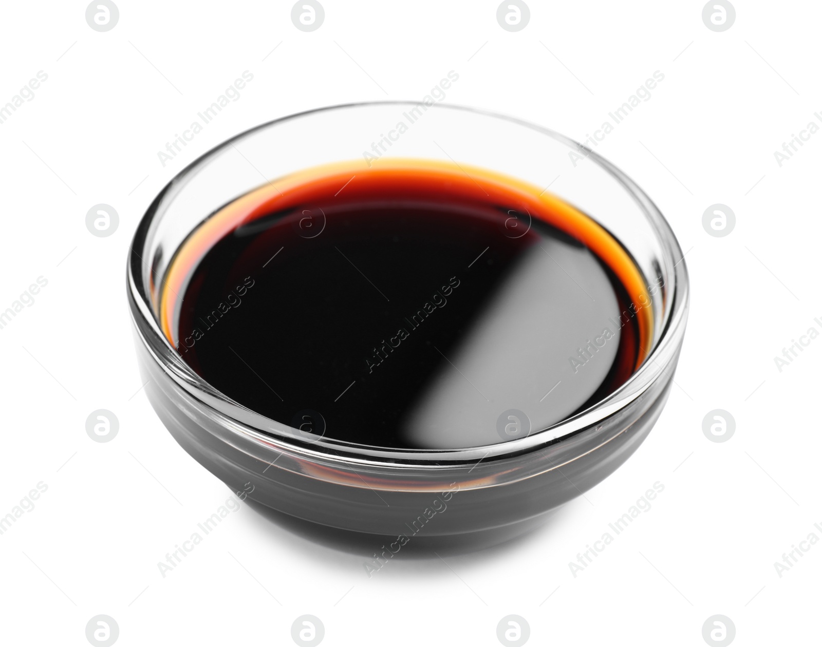 Photo of Bowl of tasty soy sauce isolated on white