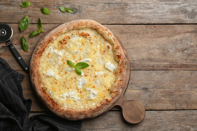 Delicious cheese pizza on wooden table, flat lay