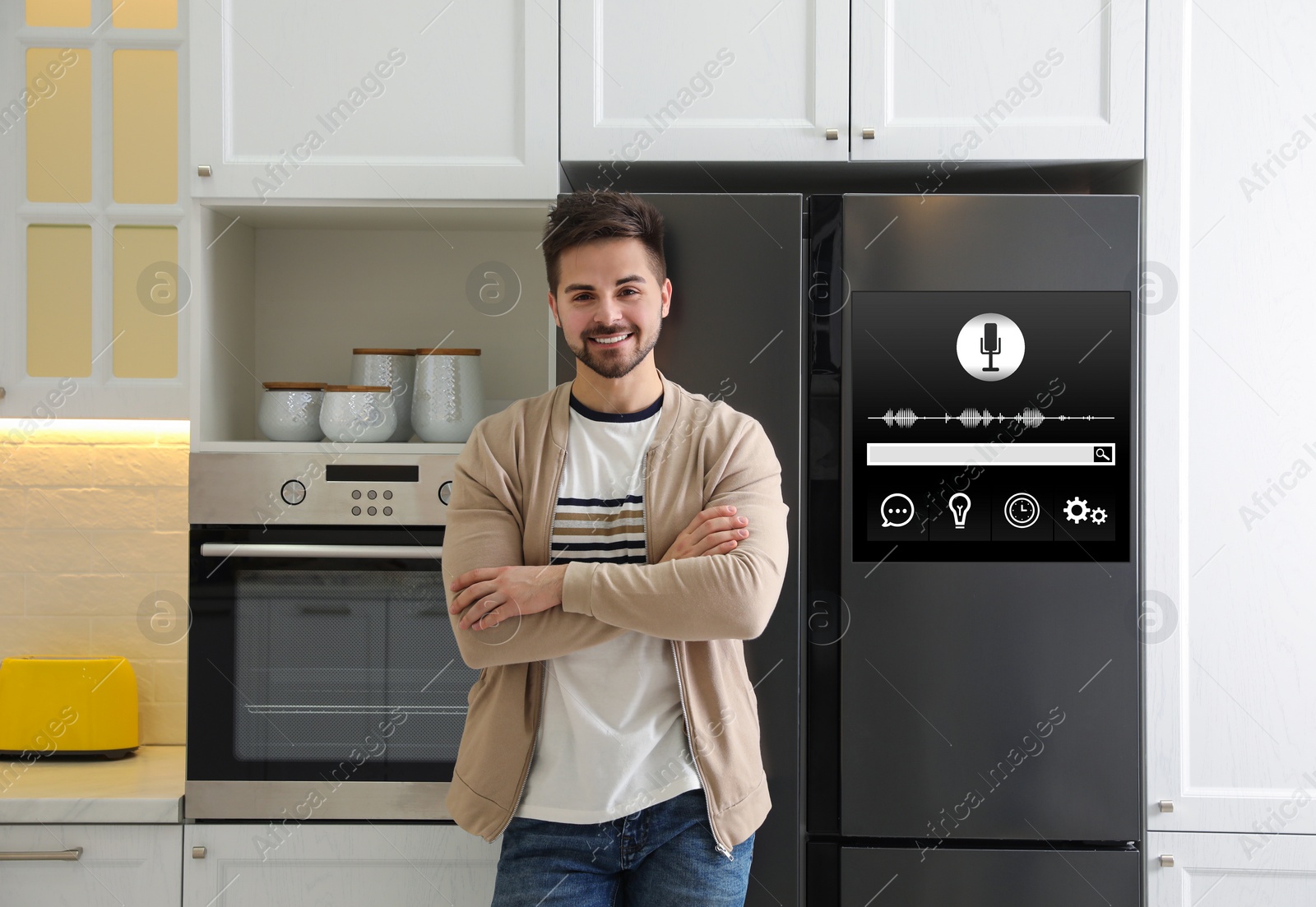 Image of Young man near smart refrigerator in kitchen