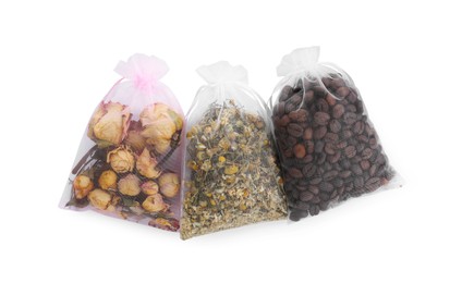 Photo of Scented sachets with dried roses, chamomile flowers and coffee beans isolated on white, top view