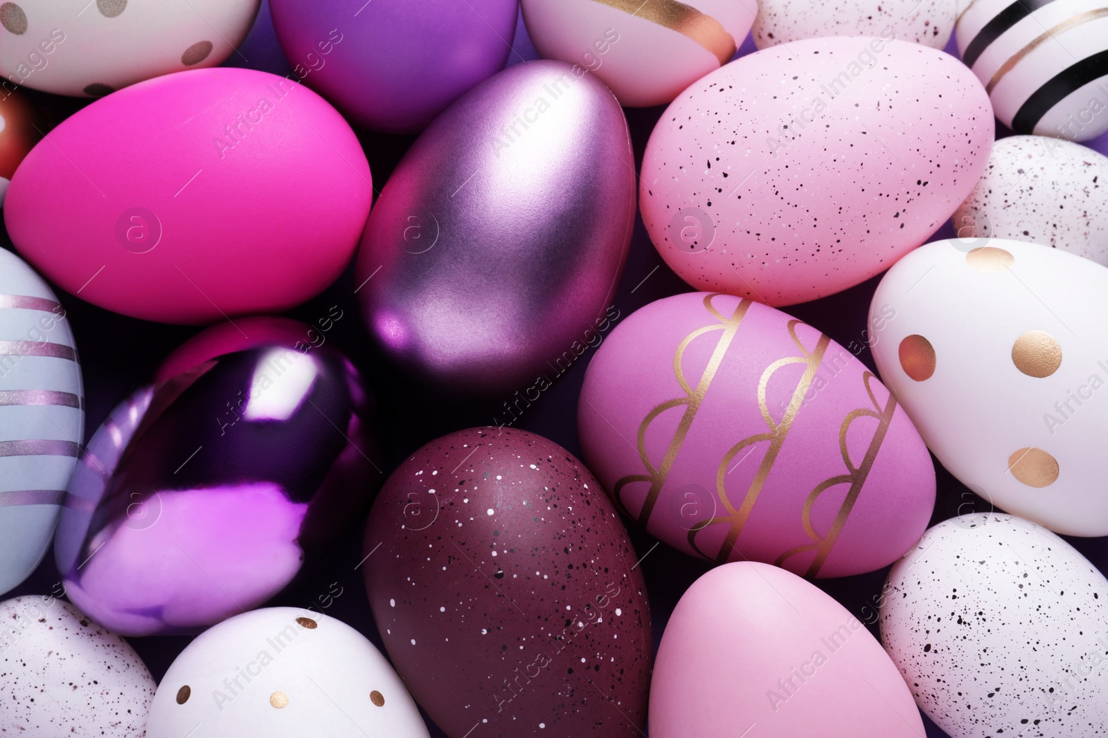 Photo of Beautifully painted Easter eggs as background, top view