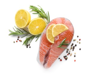 Photo of Fresh raw salmon steak with rosemary, peppercorns and lemon on white background, top view