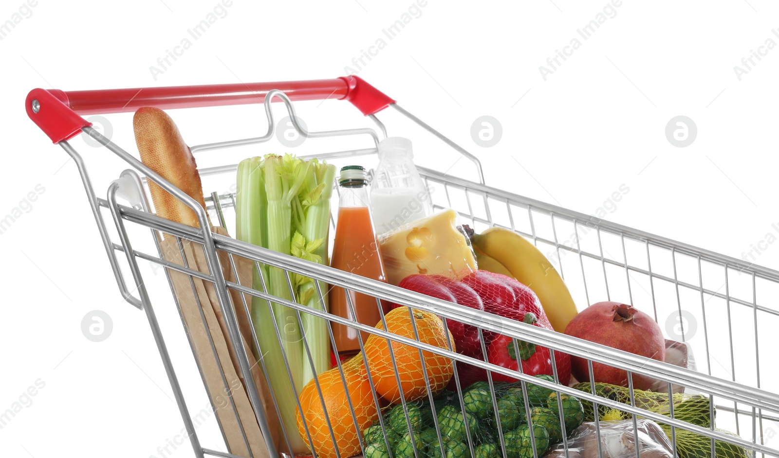Photo of Shopping cart with fresh groceries on white background
