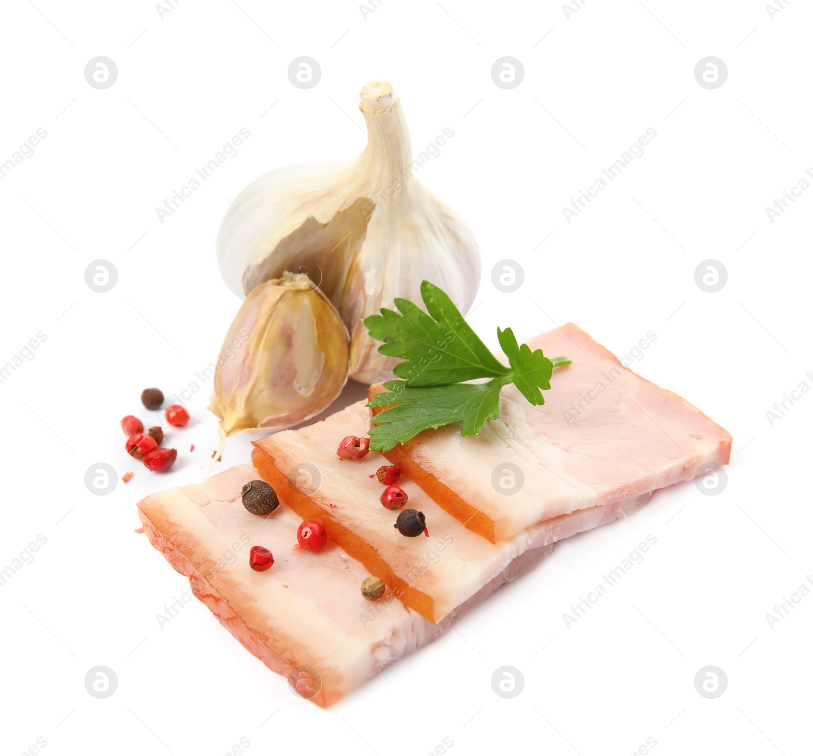 Photo of Delicious smoked bacon with parsley, garlic and peppercorns on white background