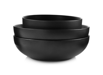 Empty black ceramic bowls on white background