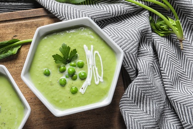 Fresh vegetable detox soup made of green peas served on table, top view