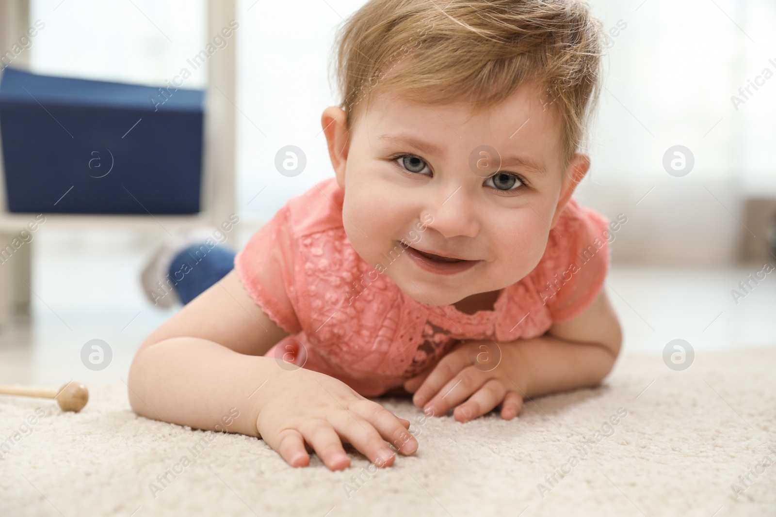Photo of Cute little baby lying on carpet at home