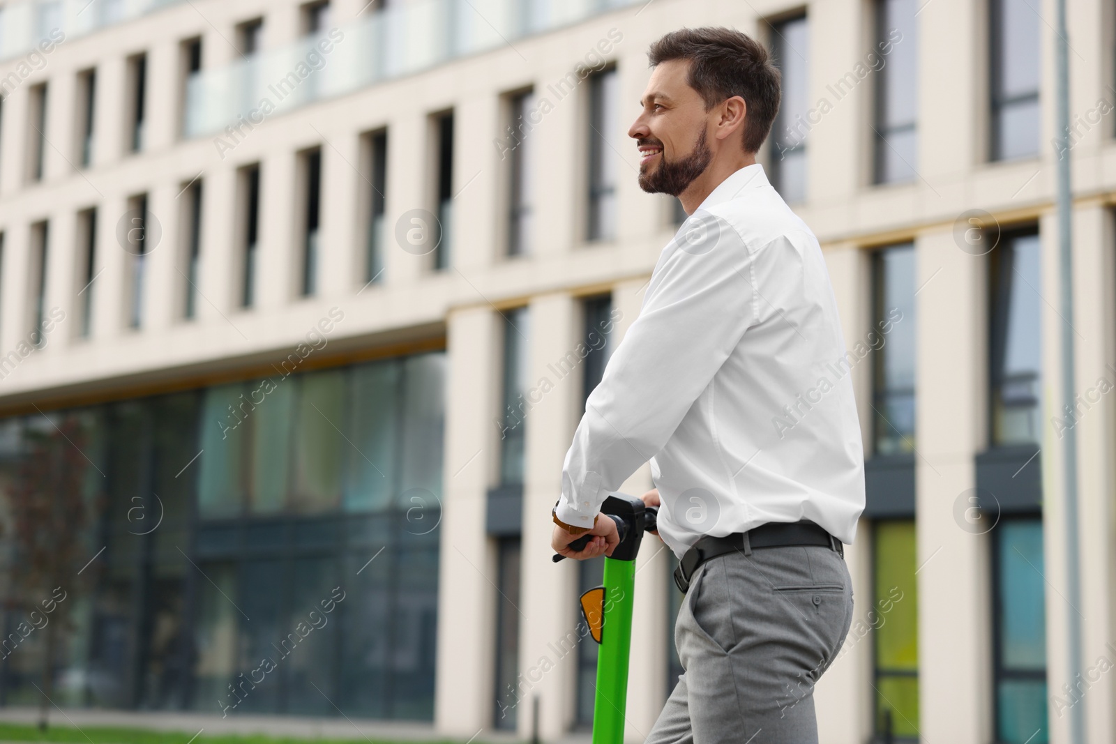 Photo of Businessman with modern kick scooter on city street, space for text