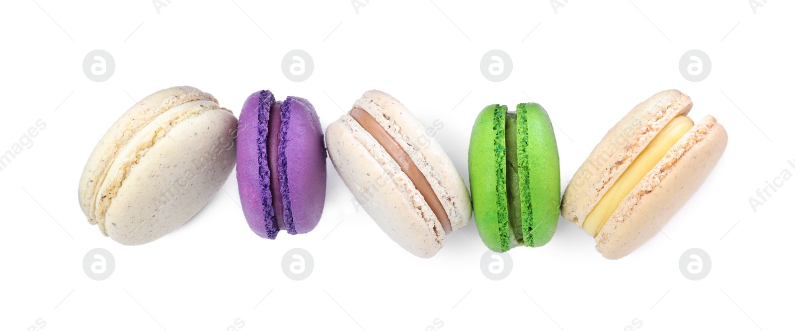 Photo of Different delicious colorful macarons on white background, top view