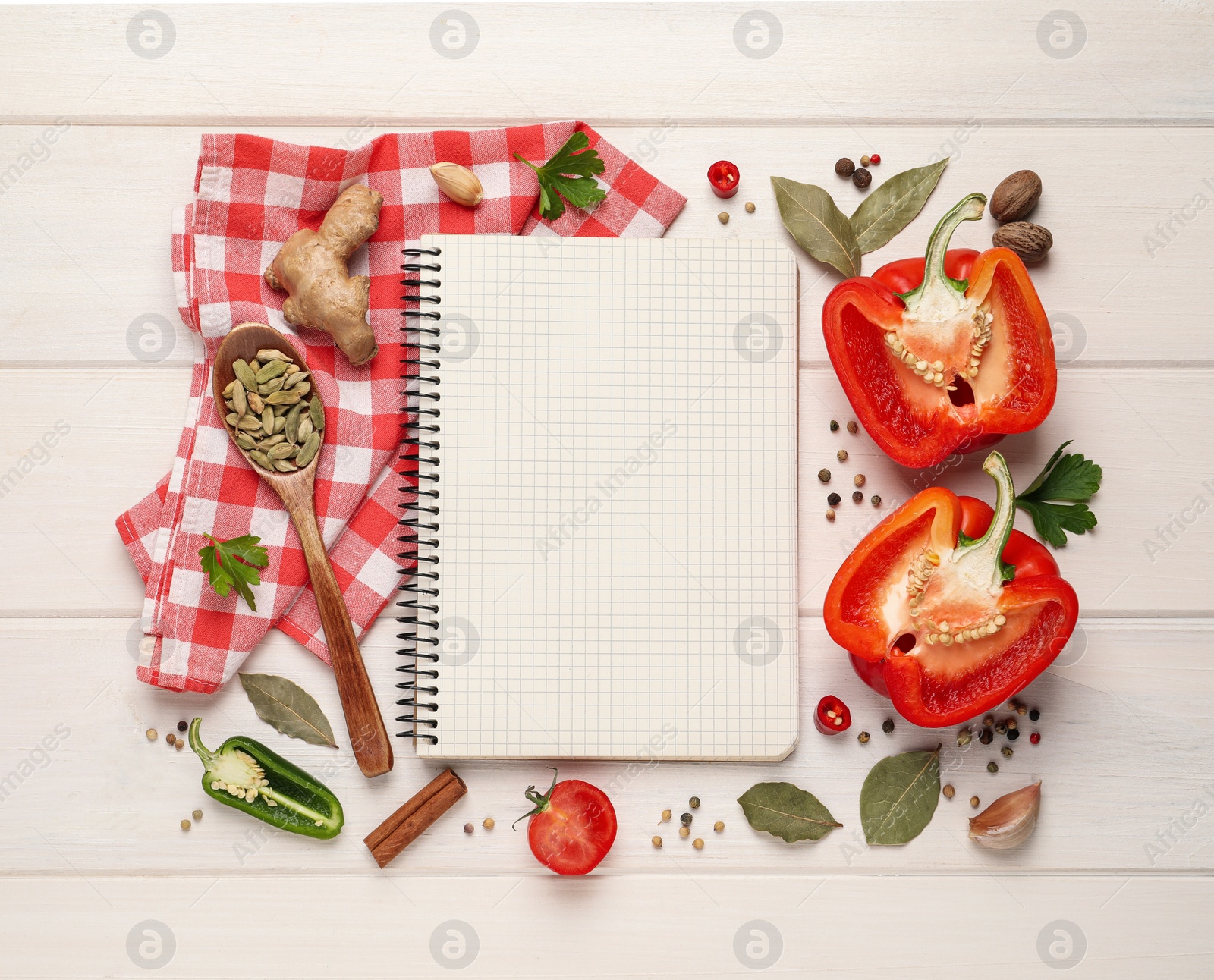 Photo of Blank recipe book and different ingredients on white wooden table, flat lay. Space for text