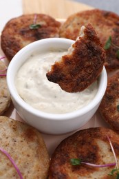 Photo of Delicious vegan cutlets and sauce on pink plate, closeup