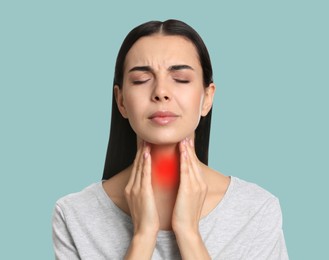 Image of Endocrine system. Woman suffering from pain in thyroid gland on light blue background