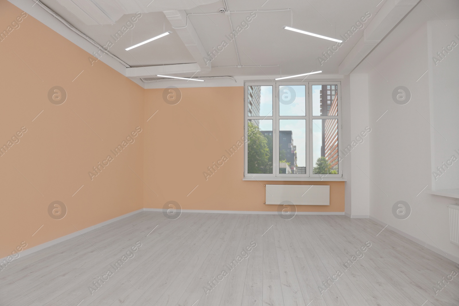 Photo of New empty office room with clean windows and beige walls