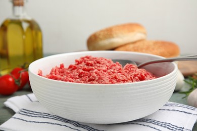 Fresh minced meat in bowl on table, closeup