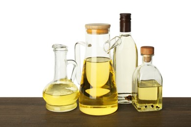 Vegetable fats. Different cooking oils on wooden table against white background