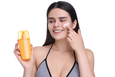 Photo of Beautiful young woman holding bottle of sun protection cream on white background