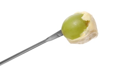 Tasty fondue. Fork with grape and melted cheese isolated on white