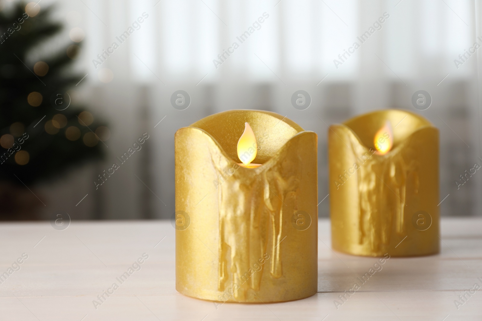 Photo of Decorative LED candles on white wooden table