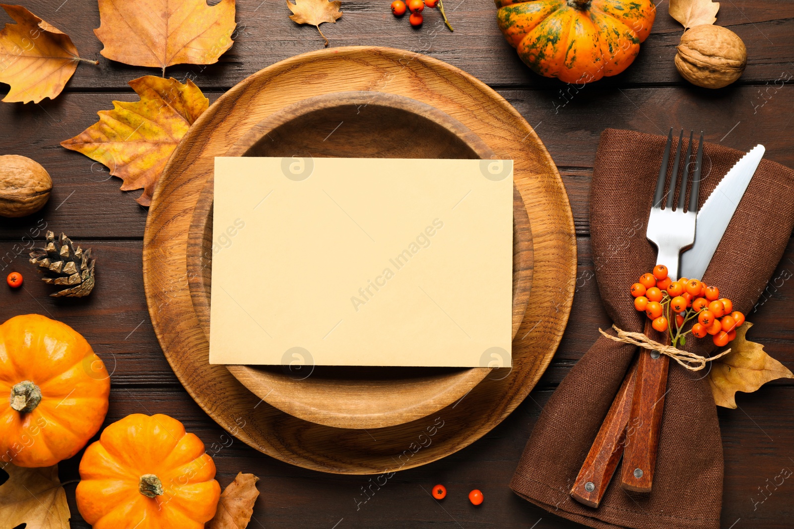 Photo of Top view of seasonal table setting with pumpkins and autumn leaves on wooden background, space for text. Thanksgiving Day