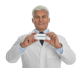 Photo of Doctor holding business card with word HEMORRHOID on white background