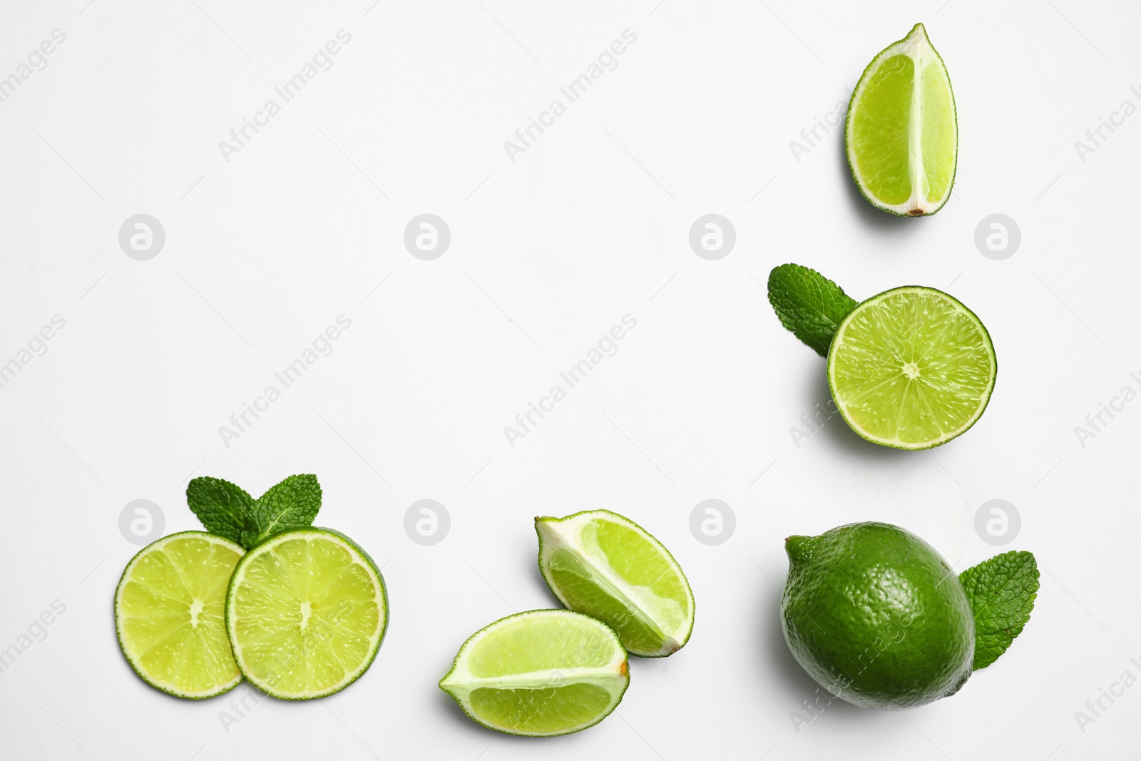 Photo of Flat lay composition with fresh juicy limes and mint on white background