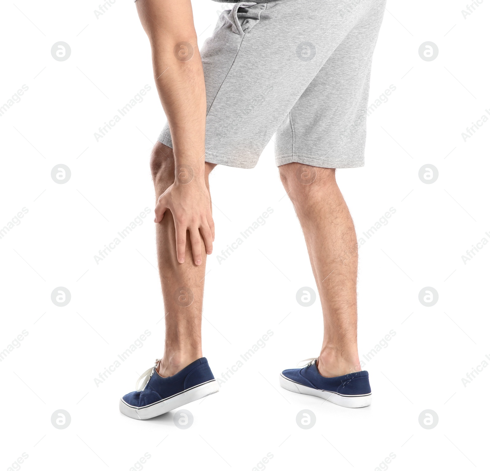 Photo of Man suffering from leg pain on white background, closeup