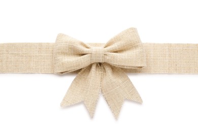 Photo of Burlap ribbon with pretty bow on white background, top view