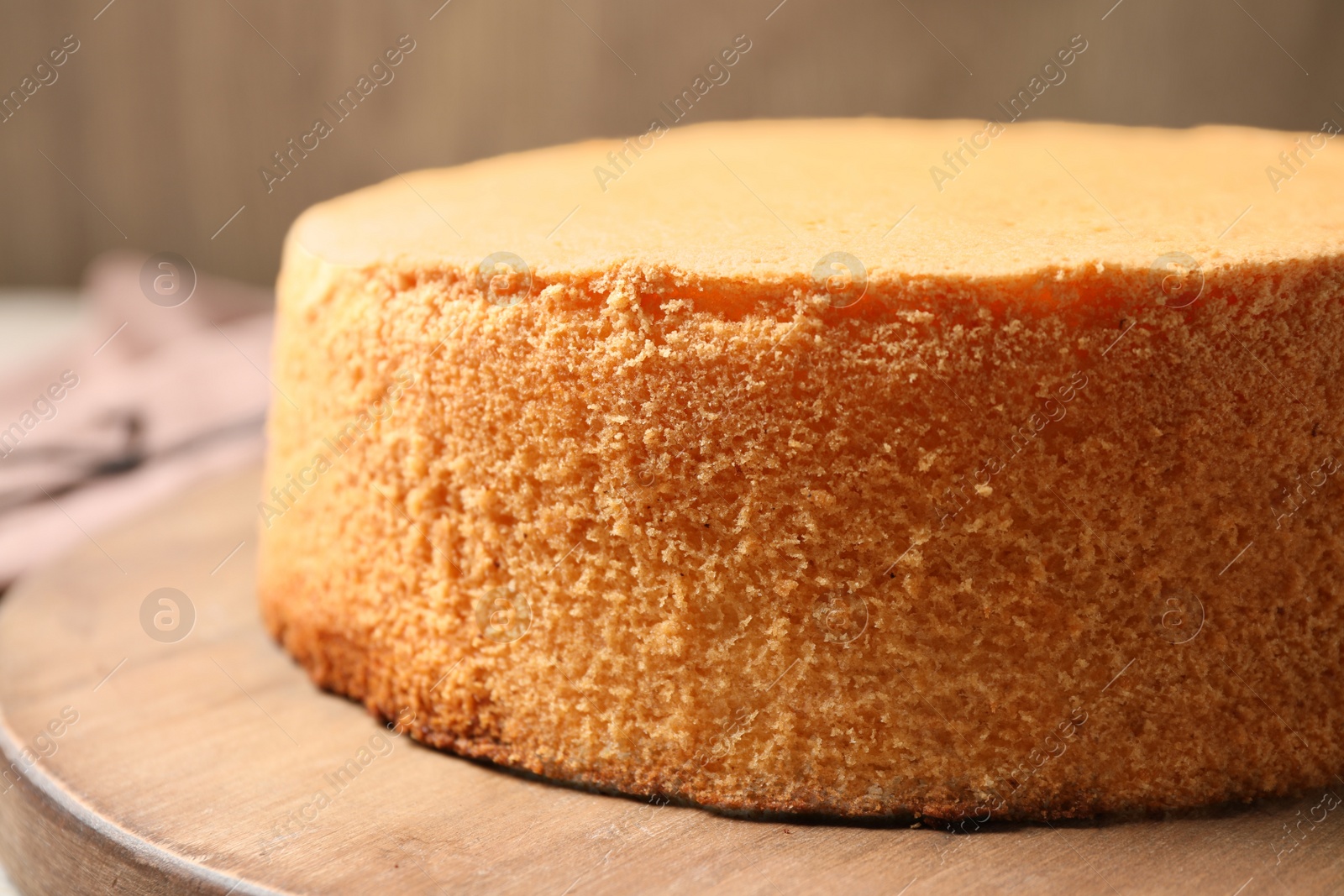 Photo of Delicious fresh homemade cake on wooden board, closeup