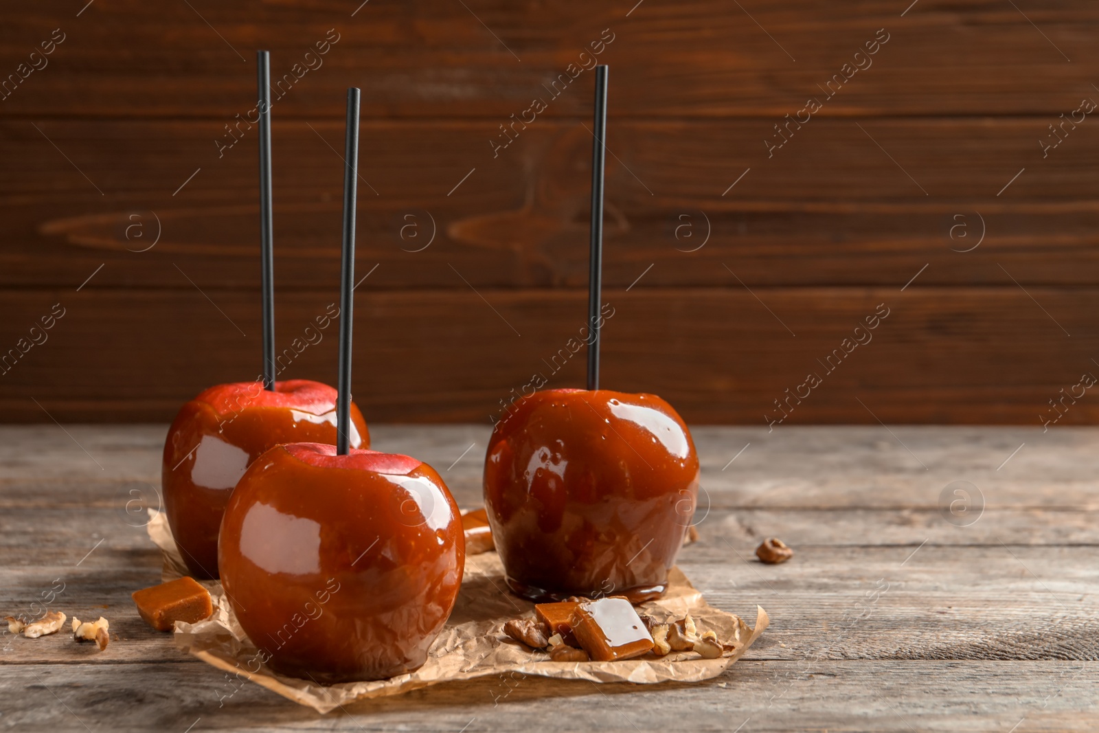 Photo of Delicious red caramel apples on table