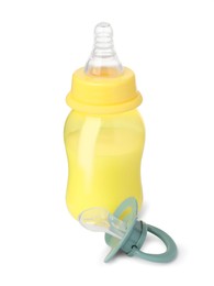 Photo of Feeding bottle with milk and pacifier on white background